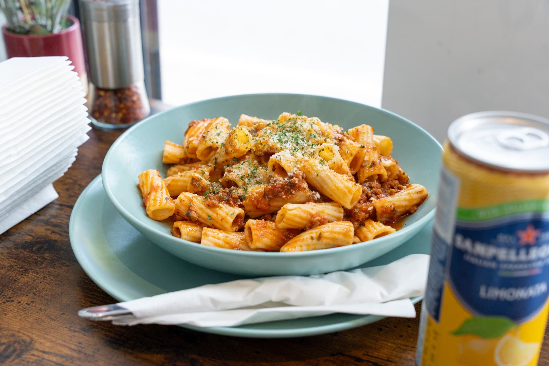 Pasta with pesto, cherry tomatoes and grated cheese, served with garlic bread